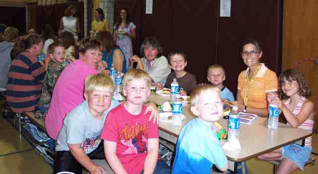    Bradyn Neubaum, Ben Sadler, Brandon Krusen and his aunt Renee, JoHannah McKibben, Christy Blume, Jeremiah Allen, Alvin Pegram and his mom Marsha all enjoy their picnic hotdogs at the Parenting Resource Picnic held at Maple Valley Elementary on the last day of school. Photo by Bethany Mallory. Thanks, Bethany!